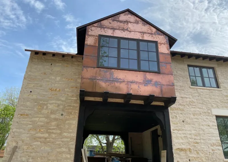 Copper metal panel facade on a stone building for Skylight Installation in O'Fallon